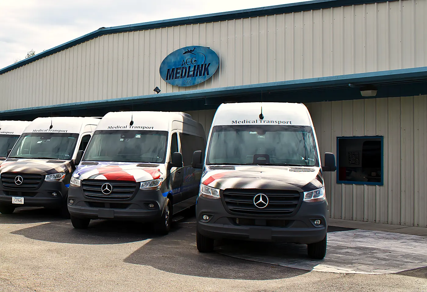 ACC Medlink Mercedes Sprinter medical transport vans parked at the ACC Medlink base