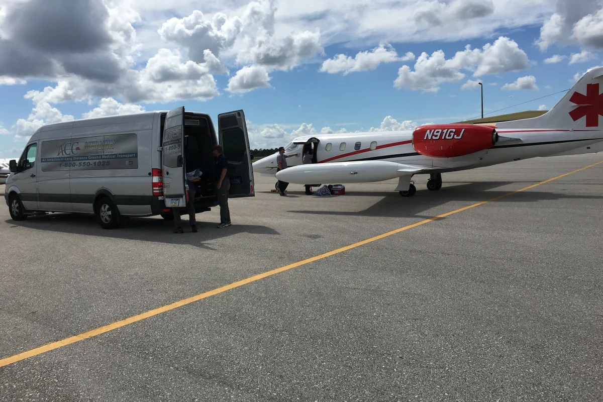 ACC Medlink transport vehicle beside a medical aircraft during a patient hand-off