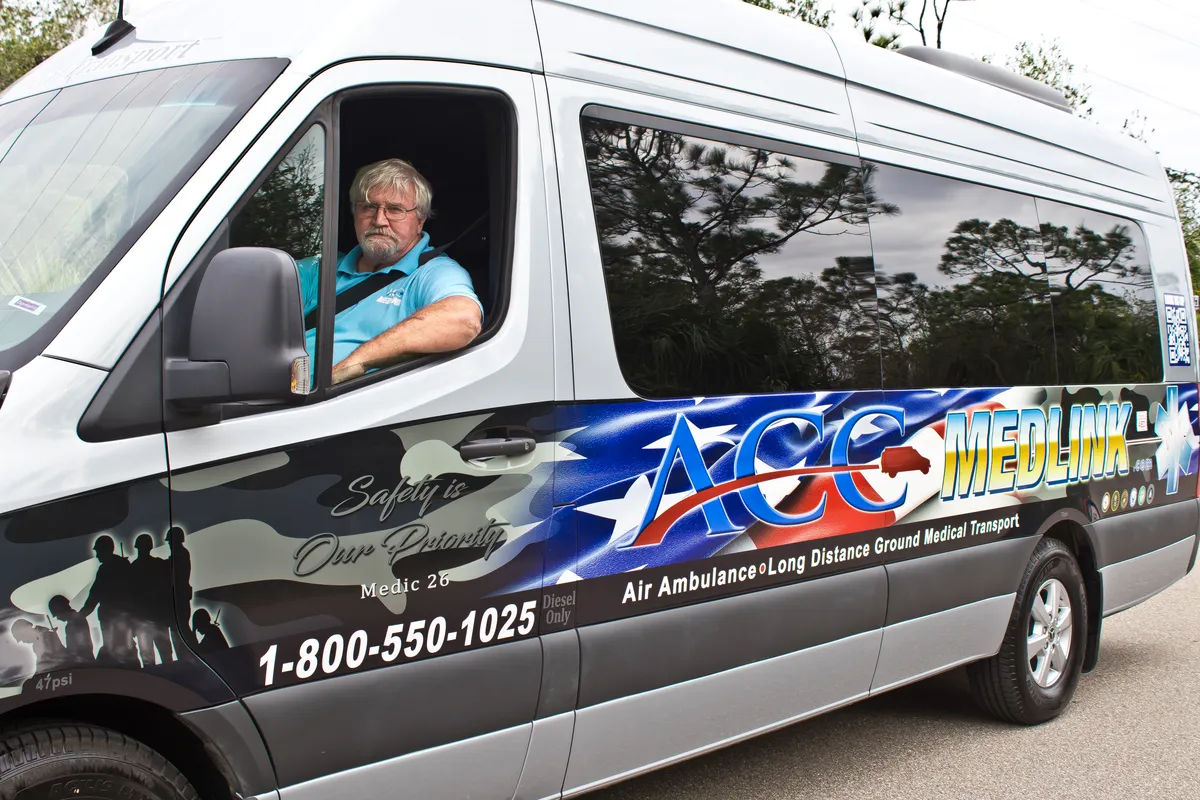 ACC Medlink driver at the wheel of a Mercedes Sprinter transport van
