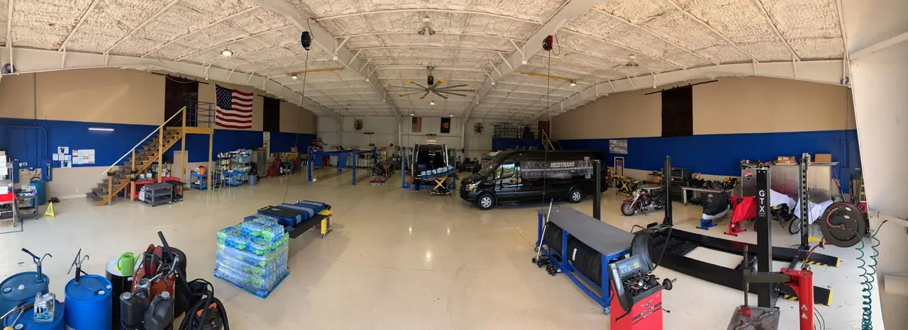 ACC Medlink maintenance garage with service lifts and a van inside