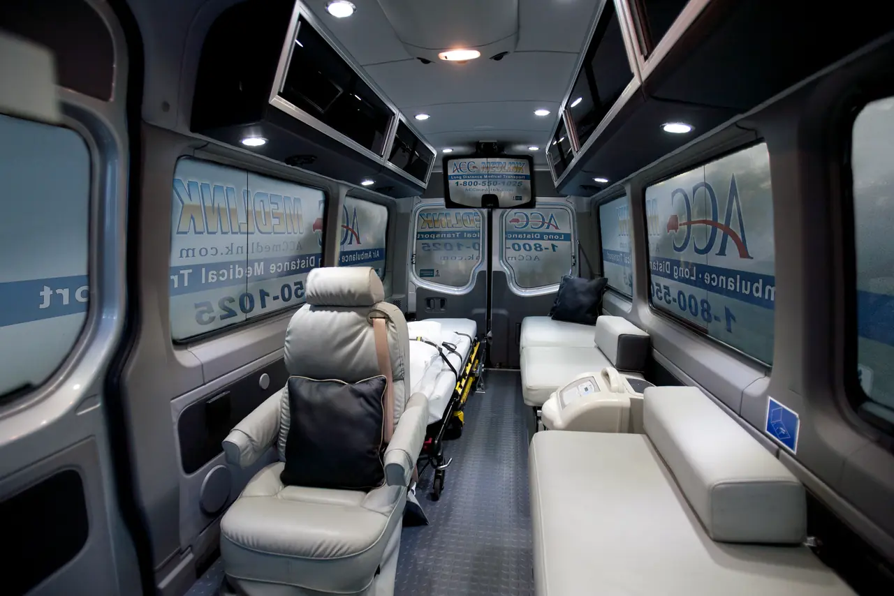 Captain's chair, bench seating and a stretcher inside an ACC Medlink Sprinter
