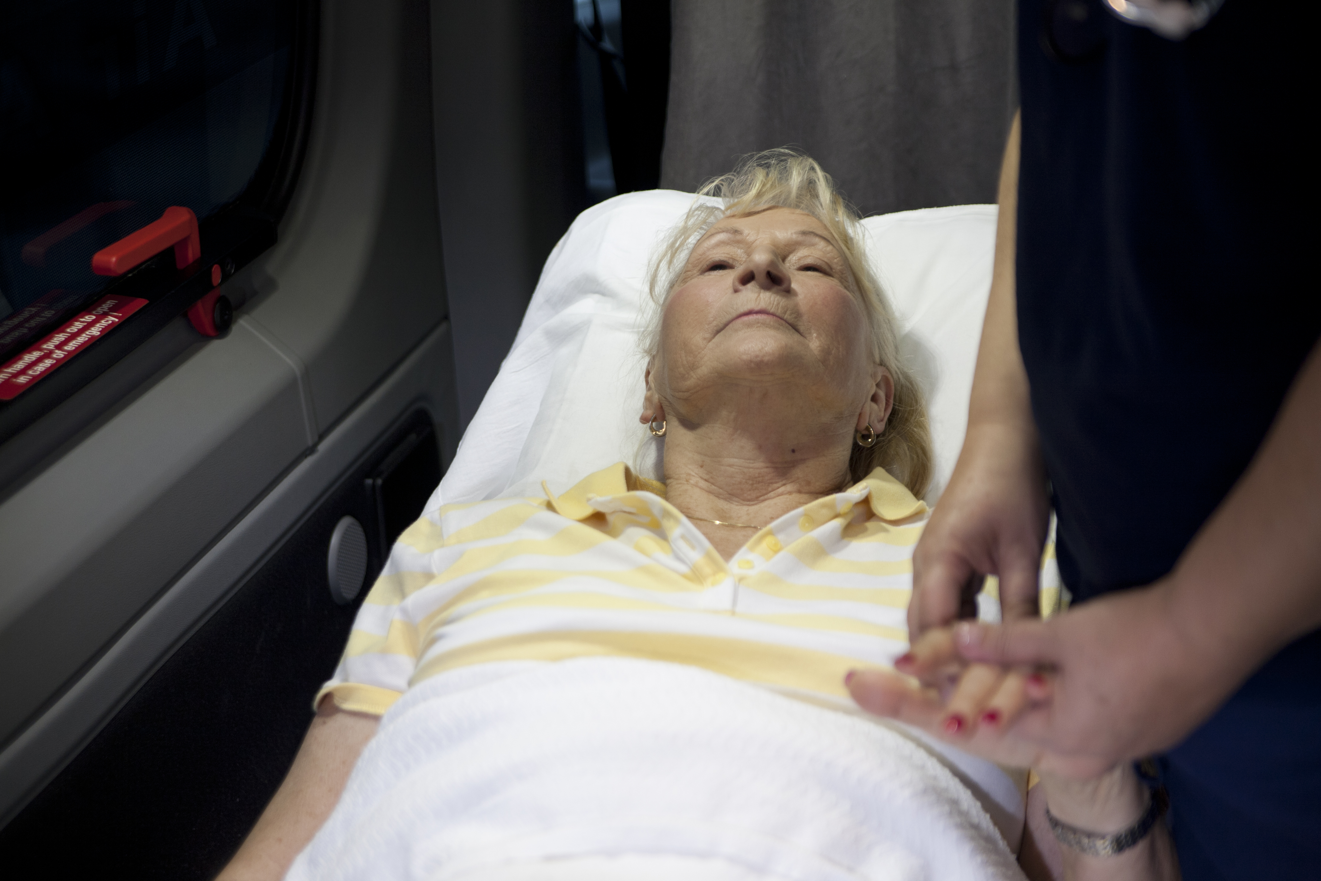 ACC Medlink's medical staff taking vitals of a patient during long-distance hospice transport
